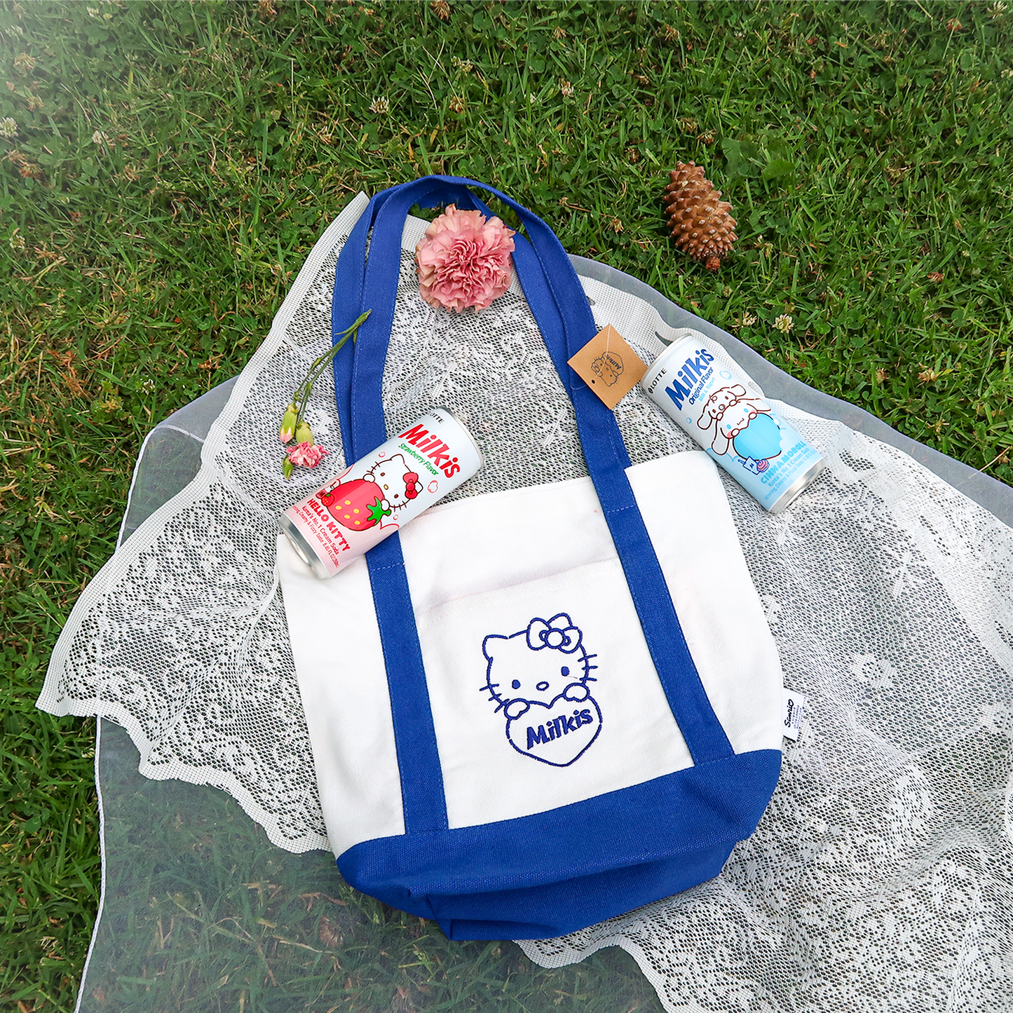 Strawberry and yogurt flavor Milkis Sanrio beverage can and Hello Kitty x Milkis eco bag on grass.